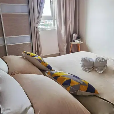 a bedroom with two beds with pillows and a window at Titiwangsa 6PX near monorail PWTC Infinity pool in Kuala Lumpur