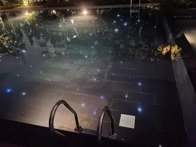 a swimming pool at night with lights at Opus Residences KL Merdeka 118 View in Kuala Lumpur