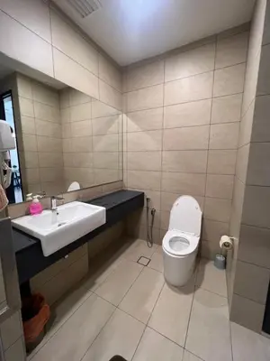 a bathroom with a toilet and a sink at Opus Residences KL Merdeka 118 View in Kuala Lumpur