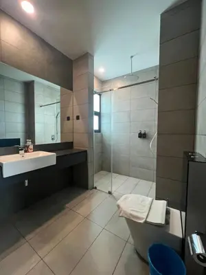 a bathroom with a shower and a sink and a toilet at Opus Residences KL Merdeka 118 View in Kuala Lumpur