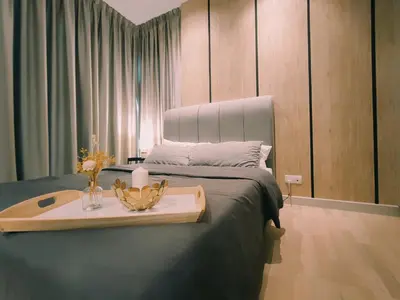 a bedroom with a bed with a tray with flowers on it at Stylish KL Suite, KLCC View, Next to LRT, Datum Jelatek By Atlantis Management in Kuala Lumpur