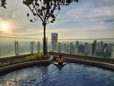 a woman in a swimming pool on top of a building at Skyline view in Bukit Bintang The Robertson 42f in Kuala Lumpur