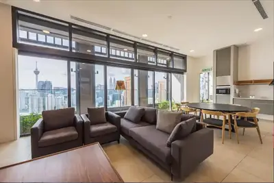 a living room with a couch and a table at Lucentia Residence By Home Horizon in Kuala Lumpur
