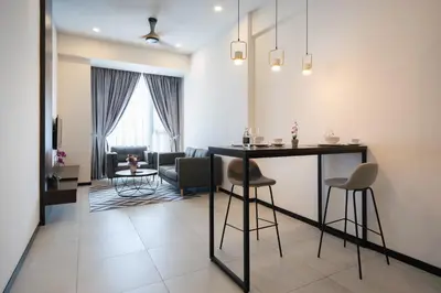 a living room with a table and chairs at Opus KL Residences by Premium Hospitality in Kuala Lumpur