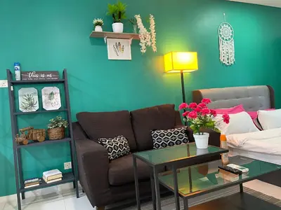 a living room with a couch and a table at Mercu Summer Suite KLCC by Kuminshu in Kuala Lumpur