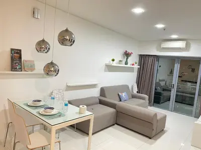 a living room with a couch and a table at Mercu Summer Suite KLCC by Kuminshu in Kuala Lumpur