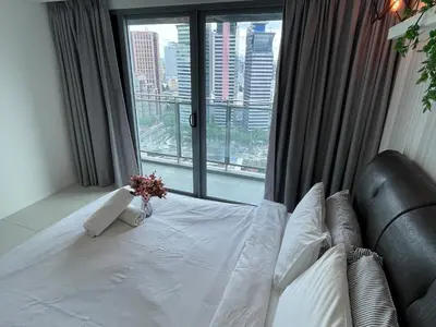 a bedroom with a bed and a large window at Mercu Summer Suite KLCC by Kuminshu in Kuala Lumpur