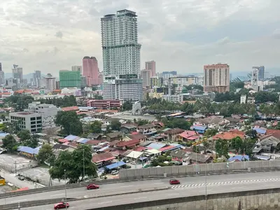 a city with buildings and a highway in the foreground at Mercu Summer Suite KLCC by Kuminshu in Kuala Lumpur