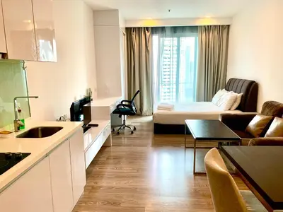 a small apartment with a bed and a living room at Roomy Suites @One Bukit Ceylon in Kuala Lumpur