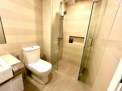 a bathroom with a toilet and a glass shower at Roomy Suites @One Bukit Ceylon in Kuala Lumpur