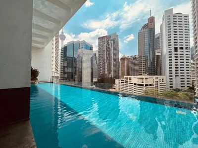 a large swimming pool with a view of a city at Roomy Suites @One Bukit Ceylon in Kuala Lumpur