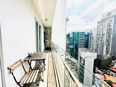 a balcony with a table and a view of the city at Roomy Suites @One Bukit Ceylon in Kuala Lumpur