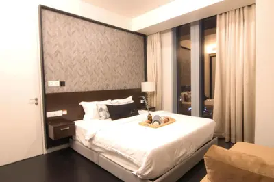 a bedroom with a large white bed in a room at Tropicana The Residences KLCC, Premium in Kuala Lumpur