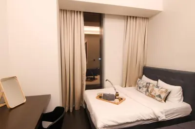 a hotel room with a bed and a mirror at Tropicana The Residences KLCC, Premium in Kuala Lumpur