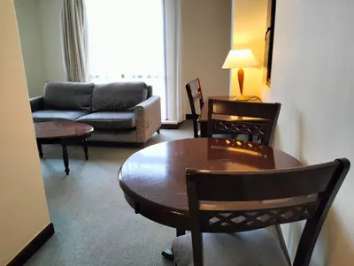 a living room with a table and chairs and a couch at TM SUITE at BERJAYA TIME SQUARE KL in Kuala Lumpur
