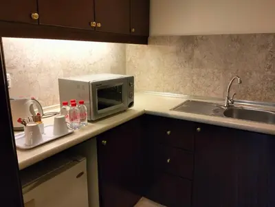 a kitchen with a microwave and a sink at TM SUITE at BERJAYA TIME SQUARE KL in Kuala Lumpur