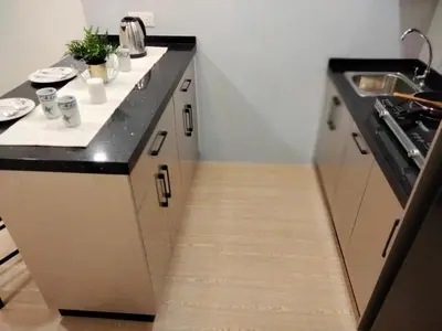 a kitchen with a black and white counter top at Bangsar Trade Center Studio 4pax I HomeBrickz in Kuala Lumpur