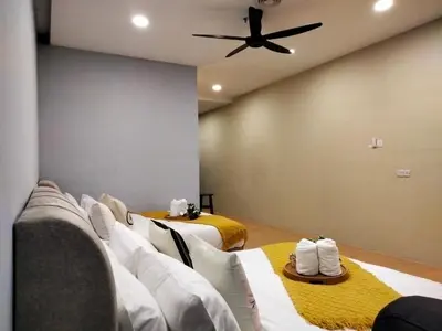 a room with two beds and a ceiling fan at Bangsar Trade Center Studio 4pax I HomeBrickz in Kuala Lumpur