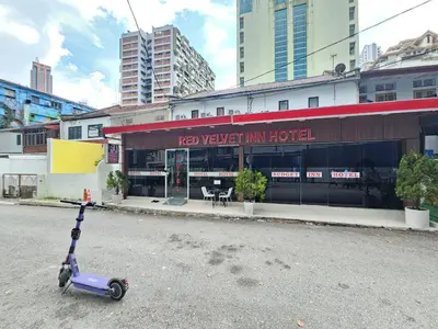 a scooter is parked in front of a hotel at Red Velvet Inn Bukit Bintang in Kuala Lumpur