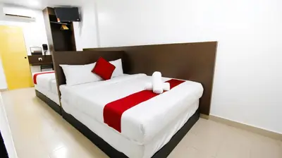 a bedroom with a bed with a red and white blanket at Red Velvet Inn Bukit Bintang in Kuala Lumpur