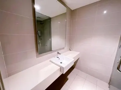 a white bathroom with a sink and a mirror at [PROMO]Connected train 1 Bedroom (ABOVE MALL)6 in Kuala Lumpur