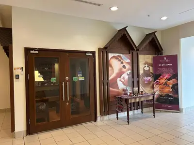a store front with glass doors and posters on the wall at KSM GLOBAL APARTMENT At TIMES SQUARE kl in Kuala Lumpur