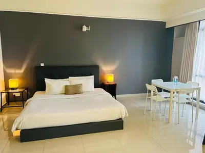 a bedroom with a bed and a table and chairs at KSM GLOBAL APARTMENT At TIMES SQUARE kl in Kuala Lumpur