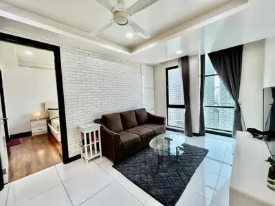 a living room with a couch and a glass table at Casa Residency Service Apartment in Kuala Lumpur