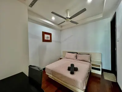 a bedroom with a bed with a ceiling fan at Casa Residency Service Apartment in Kuala Lumpur