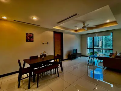 a living room with a dining table and a ceiling fan at Casa Residency Service Apartment in Kuala Lumpur