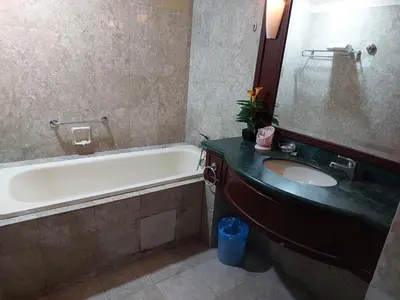 a bathroom with a tub and a sink and a bath tub at PERFECT HOME STAY at TIMES SQUARE in Kuala Lumpur