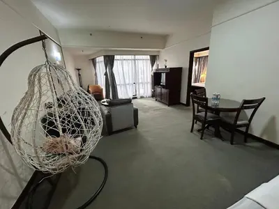 a living room with a table and a net at PERFECT HOME STAY at TIMES SQUARE in Kuala Lumpur