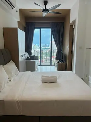 a bedroom with a large bed with a ceiling fan at The Colony KLCC view by NZV in Kuala Lumpur