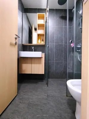 a bathroom with a sink and a shower and a toilet at The Colony KLCC view by NZV in Kuala Lumpur