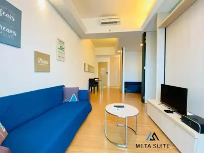 a living room with a blue couch and a table at Meta @ Swiss Garden Residence KL Bukit Bintang in Kuala Lumpur