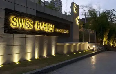 a sign on the side of a building with lights at Meta @ Swiss Garden Residence KL Bukit Bintang in Kuala Lumpur