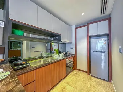 a kitchen with a sink and a refrigerator at Anggun Residence Serviced Suites By BedStay in Kuala Lumpur