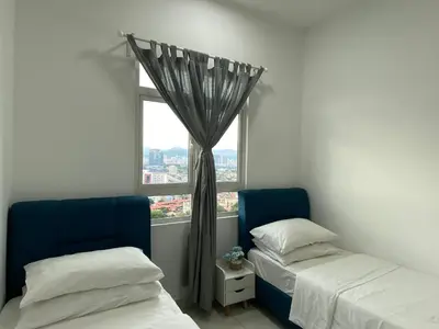 two beds in a room with a window at TR Residence 3R2B Serviced Apt 5-6pax HKL,IJN,PWTC KL in Kuala Lumpur
