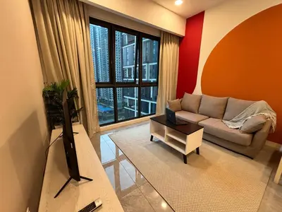 a living room with a couch and a large window at The Ooak Suites by Bamboo Hospitality in Kuala Lumpur