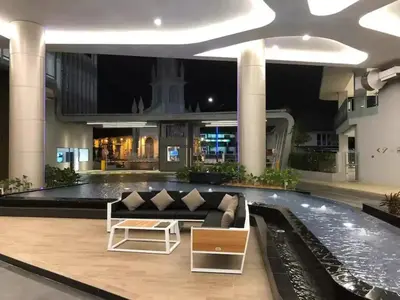 a lobby with a couch in the middle of a building at Meta @ Robertson KL Bukit Bintang in Kuala Lumpur