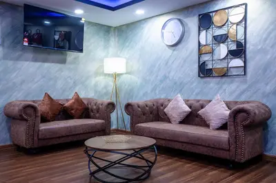 a living room with two couches and a table at Raissa Boutique Hotel in Kuala Lumpur
