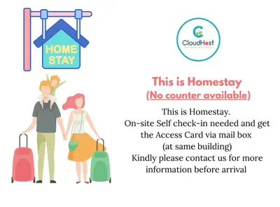 a man and a woman with luggage at a home stay sign at Anggun Homestay King Bed Studio KL City Bukit Bintang by Cloud Host in Kuala Lumpur