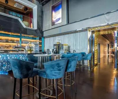 a bar with blue bar stools in a restaurant at The Platinum KLCC in Kuala Lumpur
