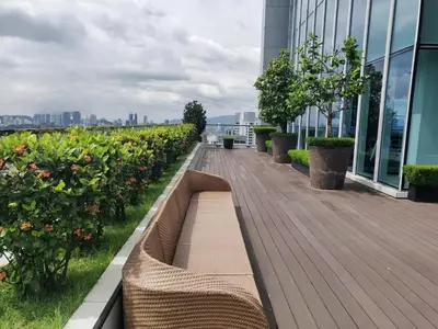 a boardwalk on the roof of a building with plants at The Platinum KLCC in Kuala Lumpur