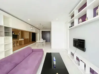 a living room with a purple couch and a table at The Platinum KLCC in Kuala Lumpur