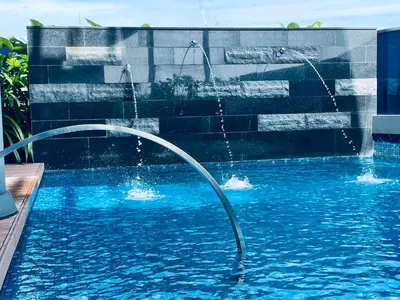 a pool with two faucets and a swimming pool at EatonResidences KLCC by MAH in Kuala Lumpur