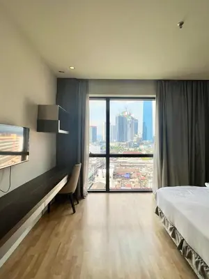a hotel room with a bed and a large window at D'Majestic by Lush Living in Kuala Lumpur