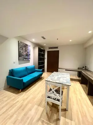 a living room with a blue couch and a table at D'Majestic by Lush Living in Kuala Lumpur