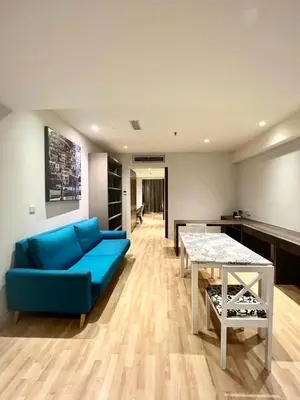 a living room with a blue couch and a table at D'Majestic by Lush Living in Kuala Lumpur