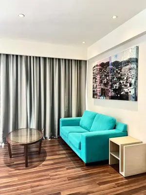 a living room with a blue couch and a table at D'Majestic by Lush Living in Kuala Lumpur